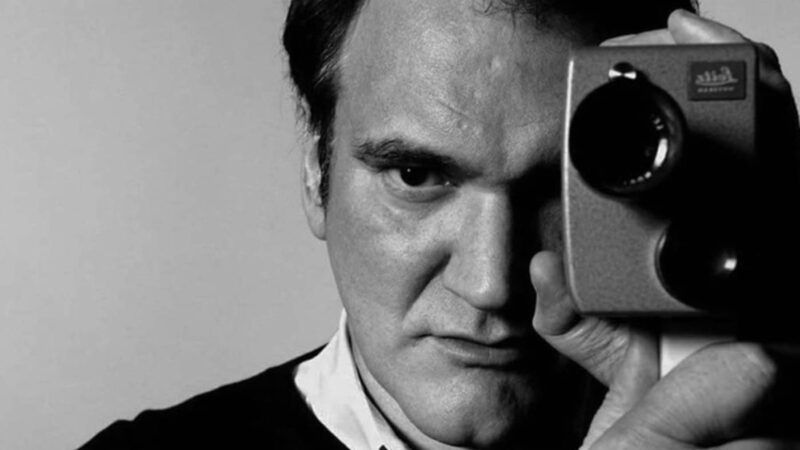 Quentin Tarantino holding a camera.