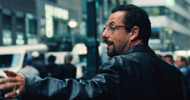 Adam Sandler as Howard Ratner in Uncut Gems, depicted with his back turned, seemingly engaged in conversation with someone on the left.