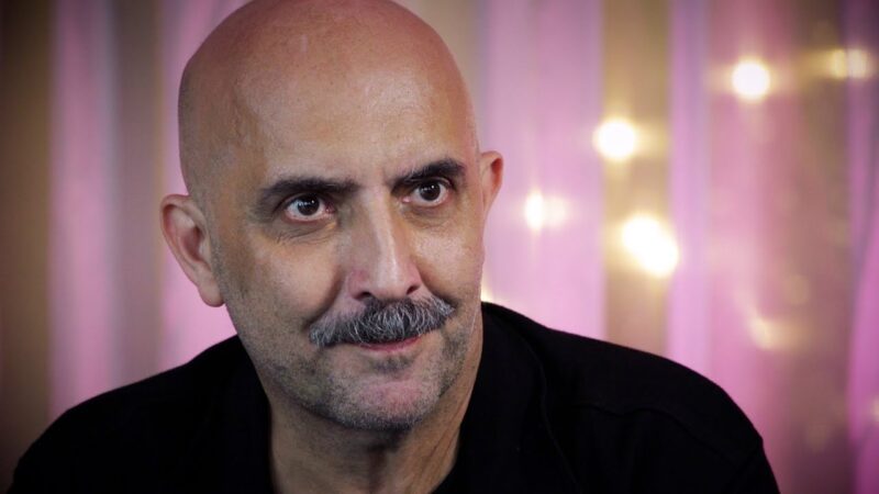 Gaspar Noé looking intently at someone.