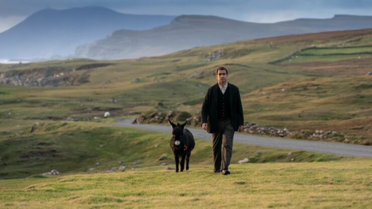 Pádraic Súilleabháin (played by Colin Farrell) from 'The Banshees of Inisherin' strolling alongside his loyal donkey.