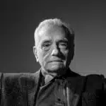 10 Signature Elements of Martin Scorsese’s Filmmaking Style! Martin Scorsese posing with both hands raised in a guilt-like manner.