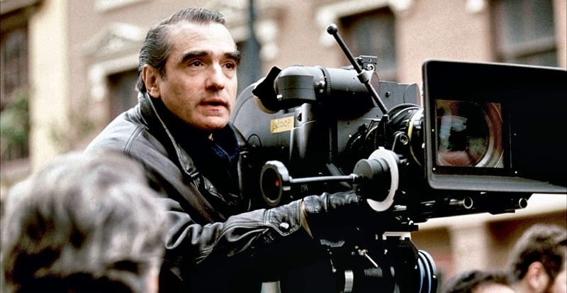 A young Martin Scorsese, filled with excitement, directing a movie with his focused gaze beside his camera.