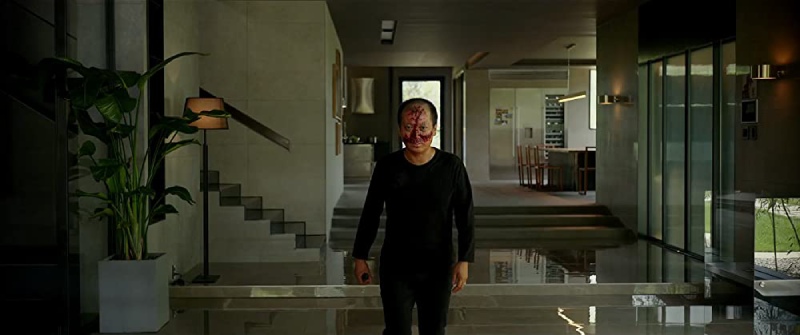 A man covered in blood in the movie Parasite.
