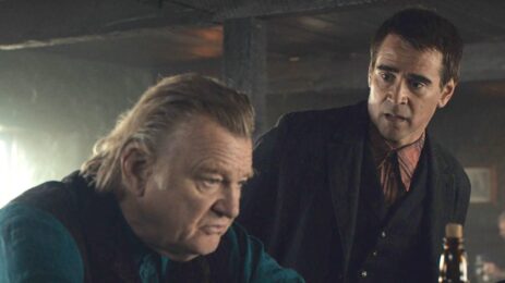 Pádraic Súilleabháin (Colin Farrell) from 'The Banshees of Inisherin' engages in a perplexed conversation with Colm Doherty (Brendan Gleeson) at a bar.