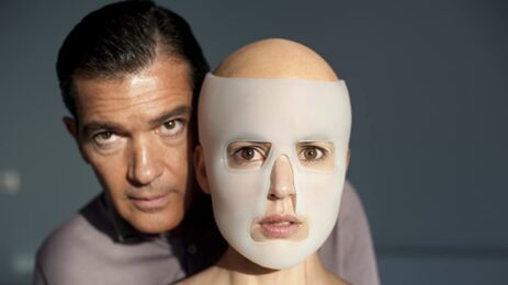 The cover of the movie "The Skin I Live In" featuring the main character played by Antonio Banderas with a surgical mask over his face.