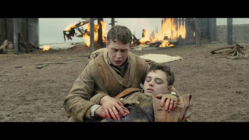 Soldier helps a wounded comrade in a poignant scene from the movie 1917.