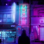 Enter the Void (2009) Review: Transcendent Cinematic Experience! Oscar standing with his back to the camera, facing a cityscape of bright neon lights.