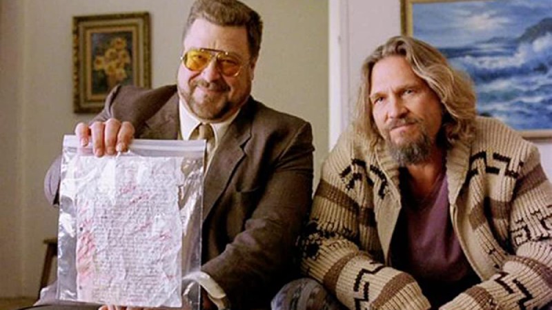The Dude and Walter Sobchak questioning their opponent, holding a document.