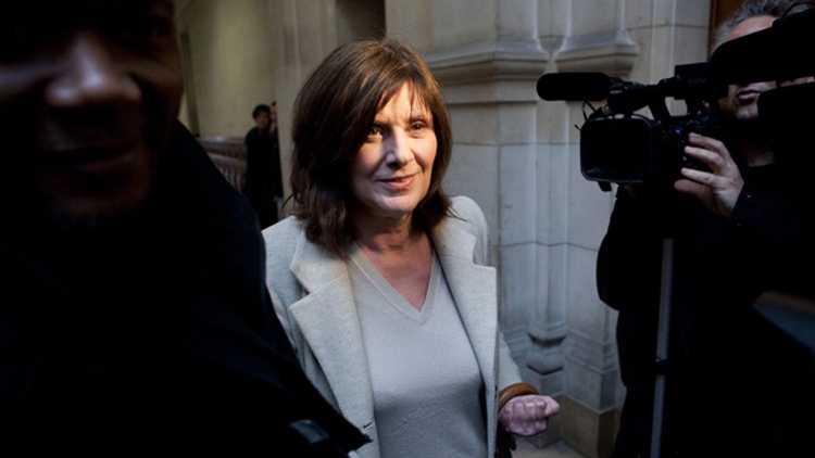 Catherine Breillat, the renowned filmmaker, wears a subtle smile as she faces the press.