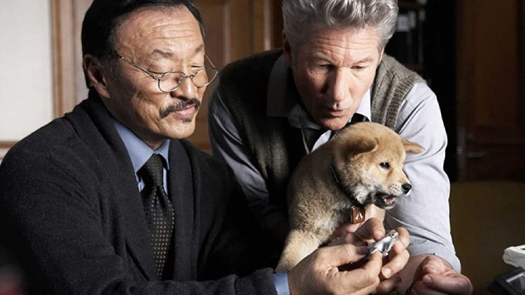 Parker Wilson (Richard Gere) from Hachi: A Dog's Tale, holding his adorable puppy Hachi.