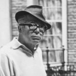 10 Signature Elements of Billy Wilder's Filmmaking Style! Billy Wilder, wearing a stylish fedora, gazes thoughtfully with a contemplative expression.