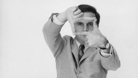 François Truffaut creatively frames a shot with his hands forming a rectangular viewfinder shape.