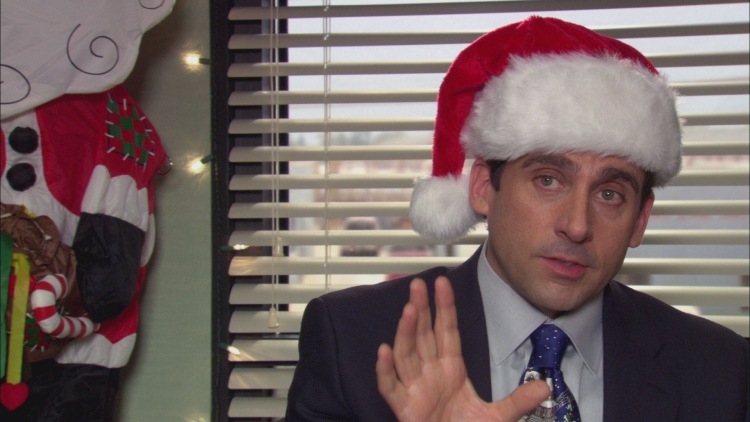 Michael Scott, portrayed by Steve Carell, wearing a New Year's party hat on his head in a festive scene from 'The Office.