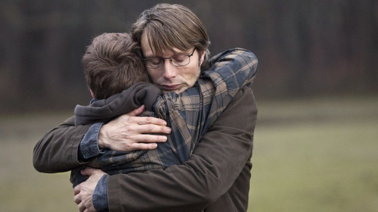 Mads Mikkelsen as Lucas in "The Hunt" (or "Jagten") shares a heartfelt embrace with his son.