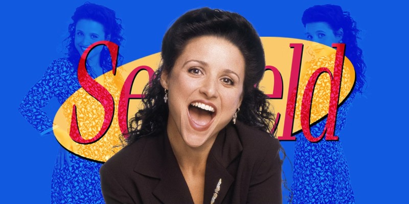 Julia Louis-Dreyfus as Elaine Benes shares an amused laugh in front of the iconic Seinfeld logo.