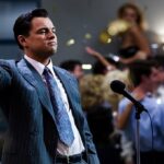 14 Fascinating Trivia About "The Wolf of Wall Street" Leonardo DiCaprio as Jordan Belfort in a scene from "The Wolf of Wall Street," raising his hand in an honorable gesture.
