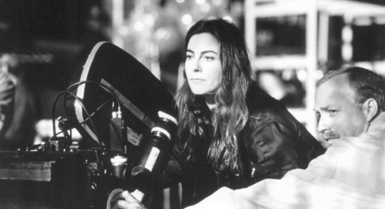 Director Kathryn Bigelow on the movie set, situated behind the camera, confidently guiding the filmmaking process.
