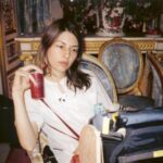 10 Signature Elements of Sofia Coppola's Filmmaking Style! Director Sofia Coppola immersed in her craft on a film set, positioned in front of a monitoring station.