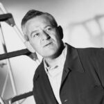 10 Signature Elements of William Wyler's Filmmaking Style! Director William Wyler captured in a side-angle pose, showcasing his authoritative and contemplative demeanor.