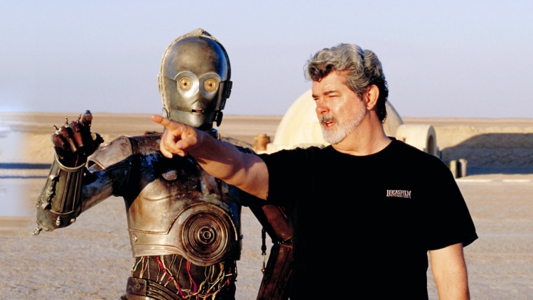 Filmmaker George Lucas gestures and directs the movie "Star Wars," with C-3PO standing nearby.