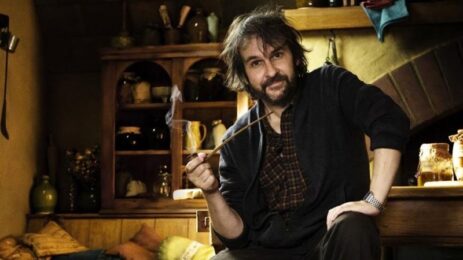 Director Peter Jackson sits on the set of "Lord of the Rings" with a pipe in hand.