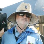 10 Signature Elements of Terrence Malick Filmmaking Style! Terrence Malick sporting a hat and sunglasses at a Red Bull event, exuding a cool and composed vibe.