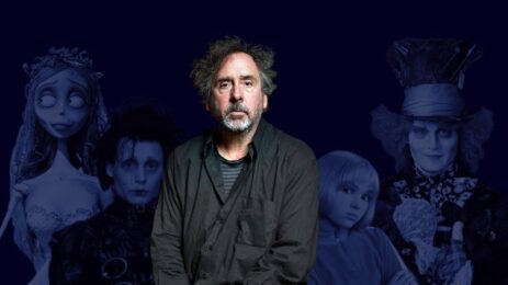 Directed by Tim Burton: The filmmaker stands in front of a collection of images from his iconic and visually captivating films.