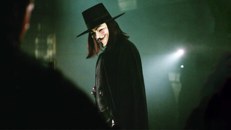 V from "V for Vendetta" casts a sideways glance in a misty and enigmatic environment.
