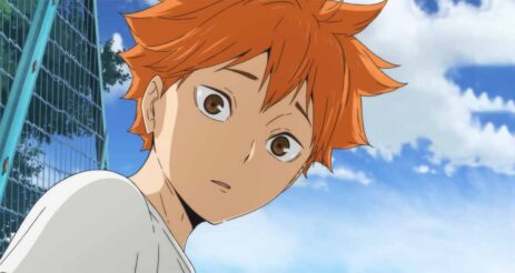 Low-angle view of Shoyo Hinata from "Haikyuu!!" anime, wearing a surprised expression as he gazes downward.