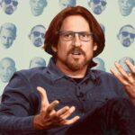 10 Signature Elements of David Ayer's Filmmaking Style! Director David Ayer seated, opening his hands in thought, with heads of characters from the films he directed behind him.