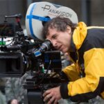 10 Signature Elements of Doug Liman's Filmmaking Style! Director Doug Liman on the film set, directing through a Panavision camera's viewfinder.