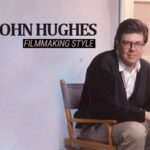 10 Signature Elements of John Hughes's Filmmaking Style! Director John Hughes seated in the director's chair, accompanied by the text "John Hughes filmmaking style."