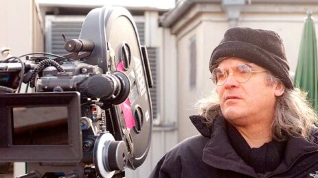 Director Paul Greengrass on the film set, focused behind the camera, actively directing a movie.