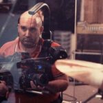 10 Signature Elements of Shane Meadows's Filmmaking Style! Director Shane Meadows on the film set, holding a camera in hand and actively directing a movie scene.