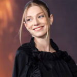 Hunter Schafer's Gender Identity Exposed: Prepare to Be Amazed! Hunter Schafer exudes a charming and alluring presence, smiling in a stylish black dress.